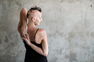lady with alopecia doing yoga pose